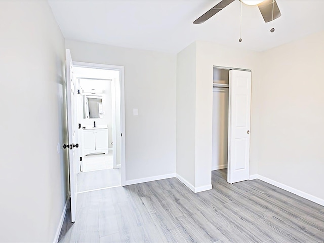 unfurnished bedroom featuring a ceiling fan, light wood-style flooring, baseboards, and a closet