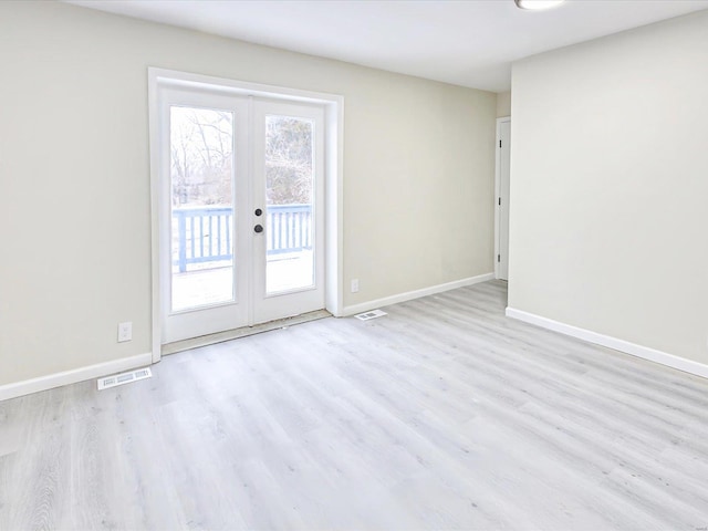 unfurnished room featuring light wood-type flooring, baseboards, and french doors