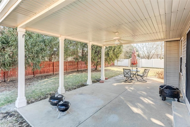 view of patio / terrace featuring outdoor dining space, a fenced backyard, and a ceiling fan