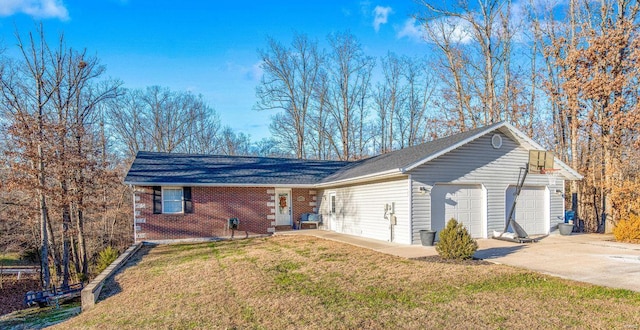 view of front of property featuring a garage, concrete driveway, brick siding, and a front lawn