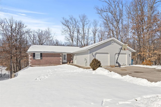 view of front of property with a garage and brick siding