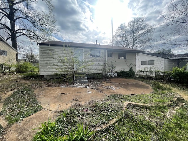 rear view of property with entry steps and a patio