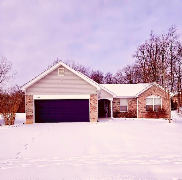 single story home with brick siding and an attached garage