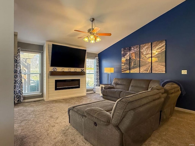 carpeted living room featuring a ceiling fan, lofted ceiling, a large fireplace, and baseboards