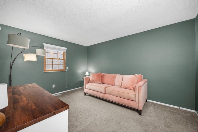 carpeted living area with a textured ceiling and baseboards