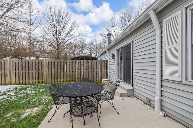 view of patio / terrace featuring entry steps, outdoor dining area, and fence