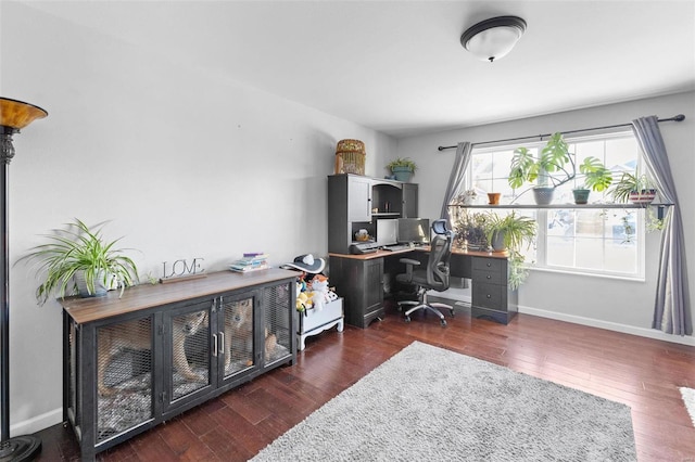 home office with dark wood-style flooring and baseboards