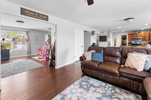 living area with dark wood-style flooring, recessed lighting, visible vents, and baseboards