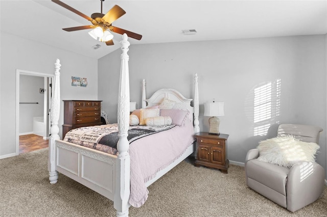 carpeted bedroom with baseboards, visible vents, a ceiling fan, lofted ceiling, and ensuite bathroom