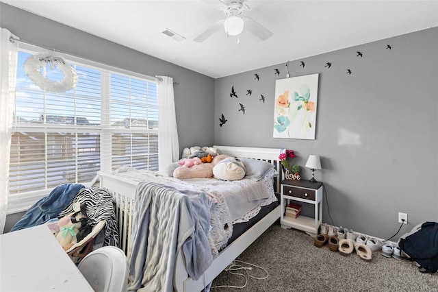 carpeted bedroom with visible vents and a ceiling fan