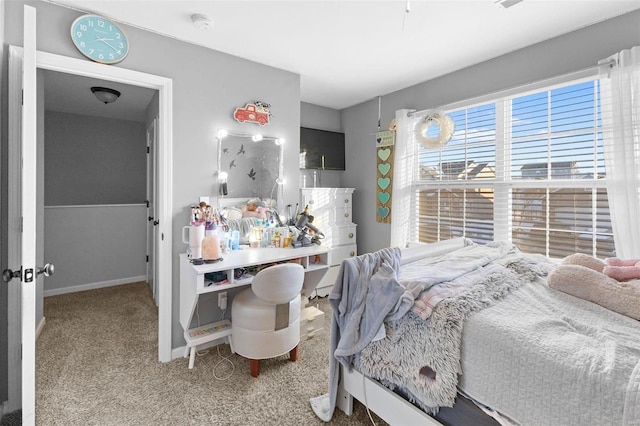 carpeted bedroom featuring baseboards