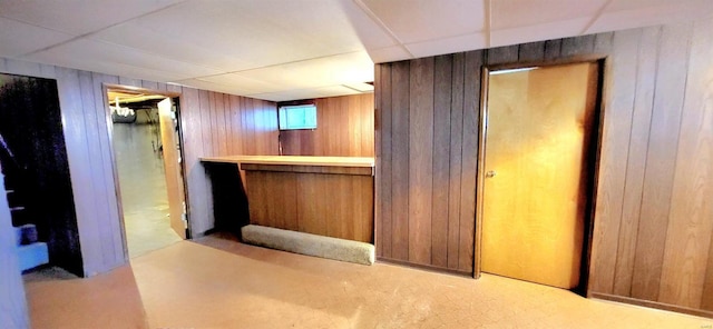 bar with wooden walls and a drop ceiling