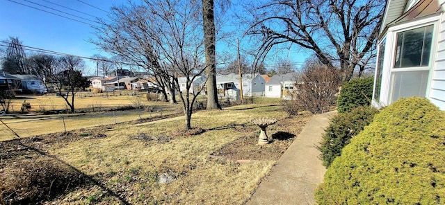 view of yard featuring fence and a residential view