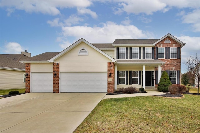 colonial house featuring a garage, driveway, brick siding, and a front yard