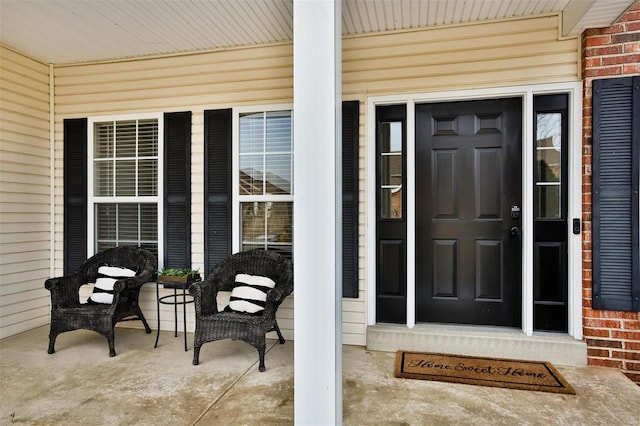 view of exterior entry with brick siding