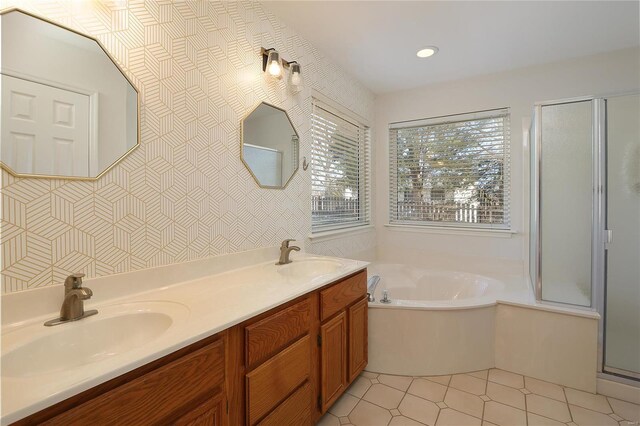 full bath featuring a garden tub, double vanity, a sink, and a shower stall