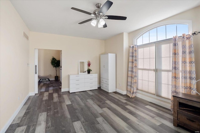 interior space featuring a ceiling fan, wood finished floors, visible vents, and baseboards