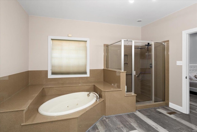 bathroom with a whirlpool tub, wood finished floors, a shower stall, and visible vents