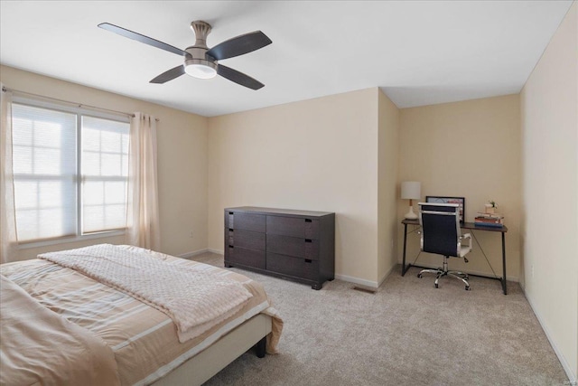 carpeted bedroom with a ceiling fan and baseboards