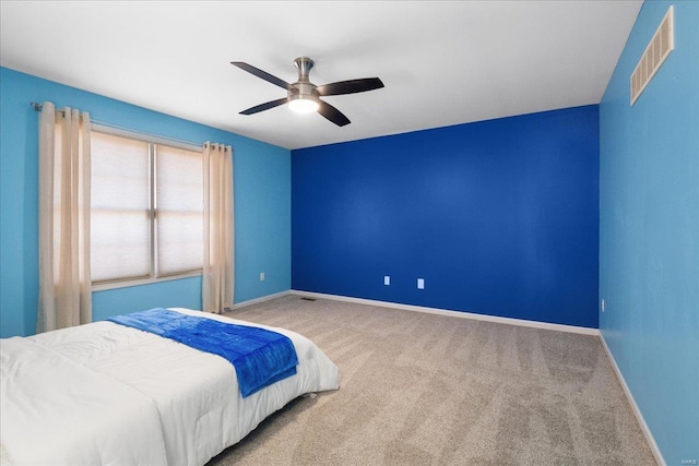 bedroom featuring a ceiling fan, carpet, visible vents, and baseboards