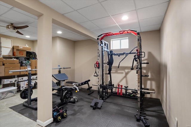 exercise room with a paneled ceiling and recessed lighting