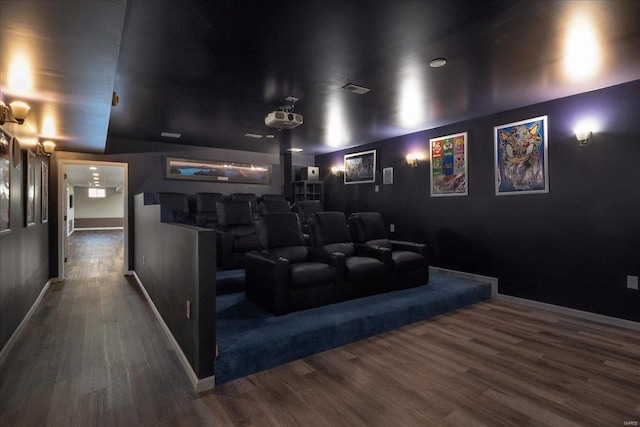 home theater room featuring baseboards and wood finished floors