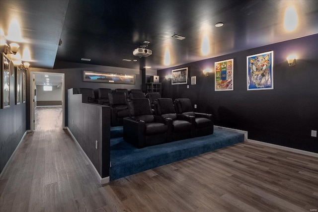 home theater featuring baseboards and wood finished floors