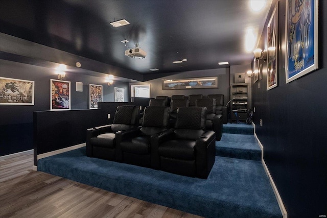 cinema room with baseboards and wood finished floors