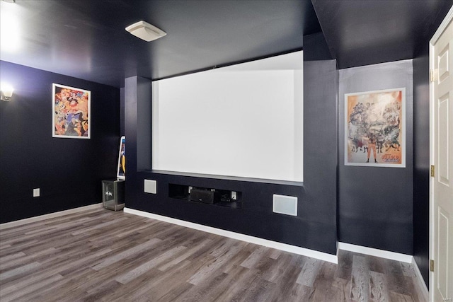 cinema room featuring wood finished floors and baseboards