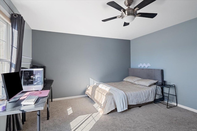 carpeted bedroom featuring ceiling fan and baseboards