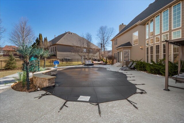 view of pool featuring a patio area and fence