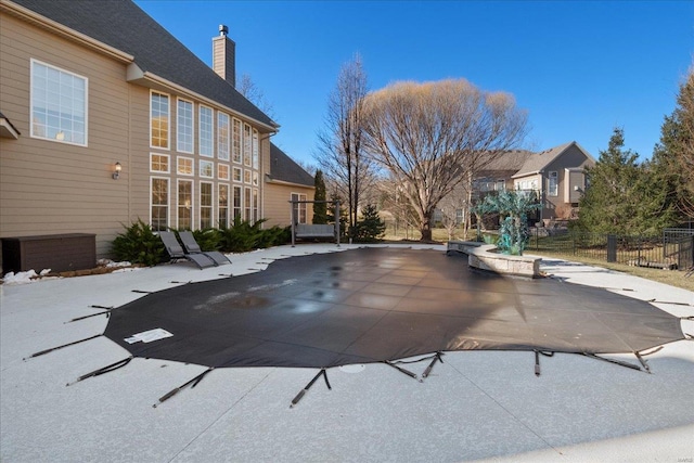 view of pool with fence and a patio