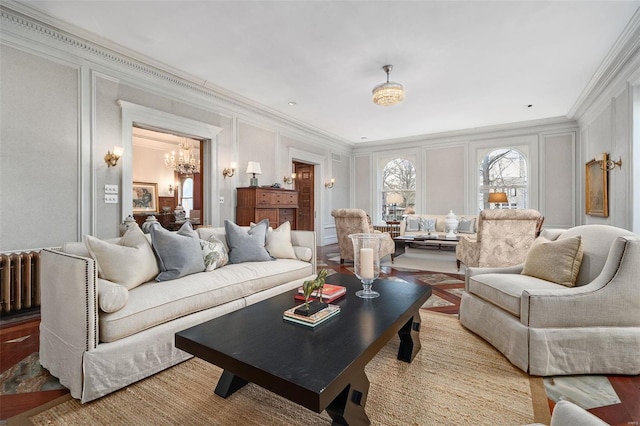 living area with radiator, ornamental molding, and a decorative wall