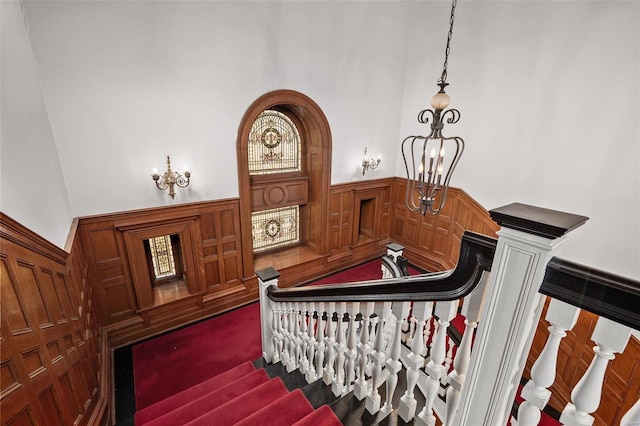 staircase featuring a wainscoted wall