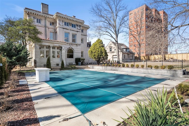 view of swimming pool with fence