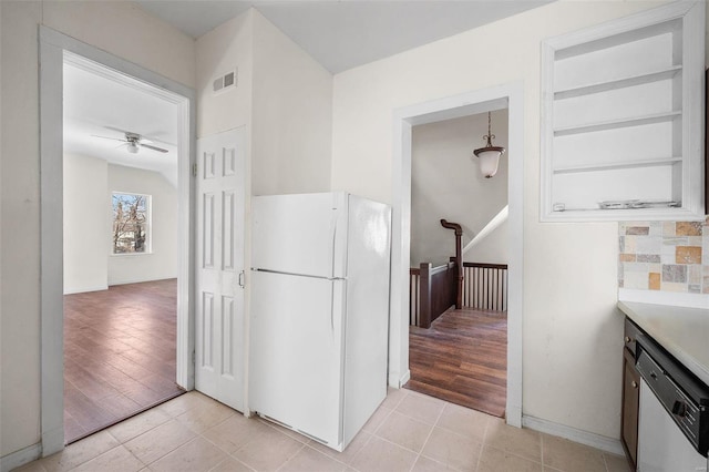 kitchen featuring ceiling fan, light tile patterned floors, visible vents, freestanding refrigerator, and dishwasher