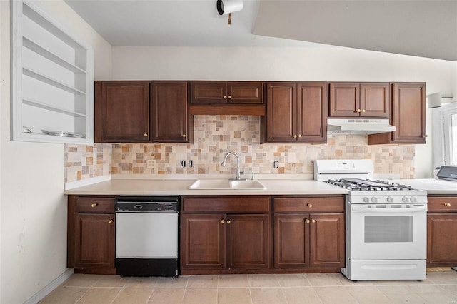 kitchen with white appliances, a sink, under cabinet range hood, and backsplash