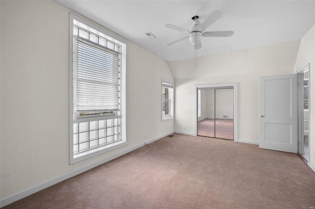 unfurnished bedroom with carpet floors, a closet, multiple windows, and baseboards