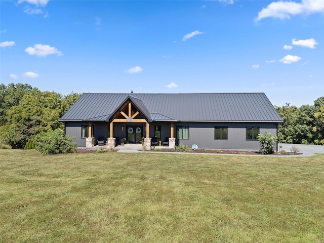 modern farmhouse style home with a standing seam roof, metal roof, and a front yard