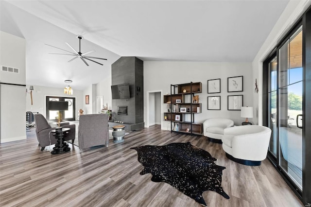 living room with plenty of natural light, a fireplace, visible vents, and wood finished floors