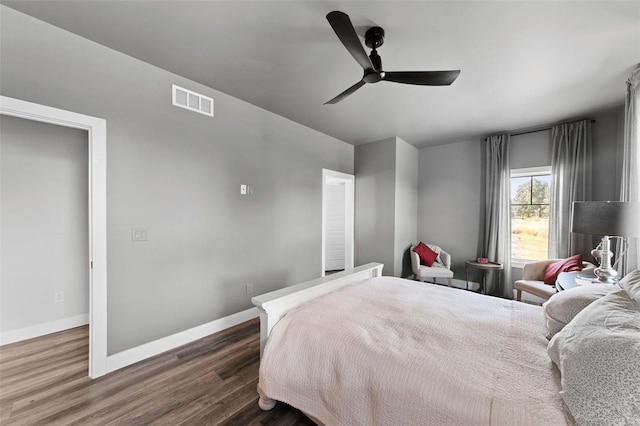 bedroom with dark wood-style floors, baseboards, visible vents, and a ceiling fan