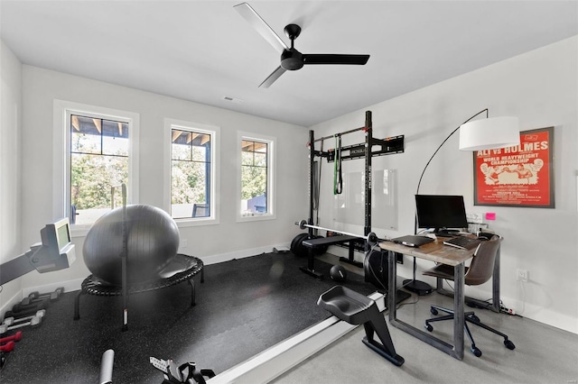 exercise area featuring visible vents, a ceiling fan, and baseboards