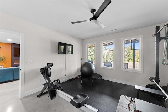 workout room with baseboards, visible vents, and ceiling fan