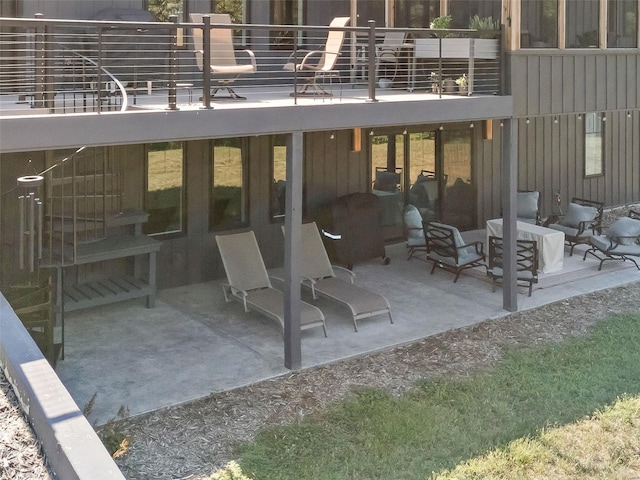 exterior space featuring a balcony, a fire pit, and a patio