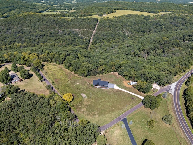 birds eye view of property featuring a view of trees