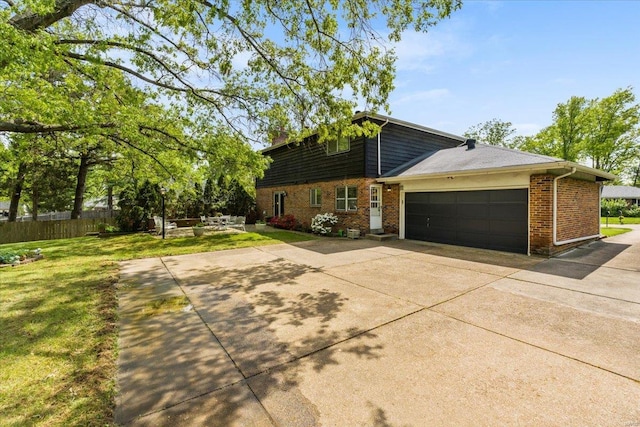 view of property exterior featuring brick siding, a garage, a lawn, and concrete driveway