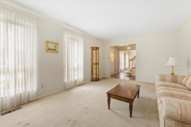 living room featuring crown molding, carpet, stairs, baseboards, and visible vents