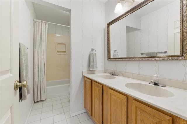 full bathroom with double vanity, shower / bath combination with curtain, a sink, and tile patterned flooring