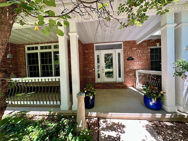 entrance to property featuring brick siding