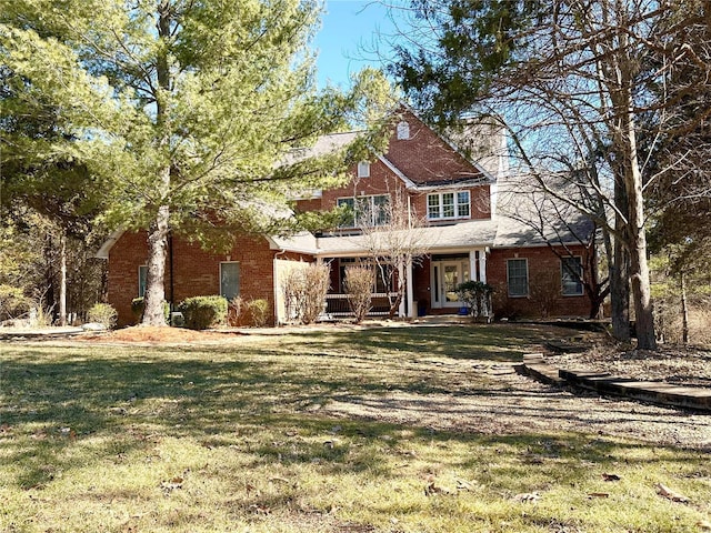 view of front of house with brick siding and a front yard